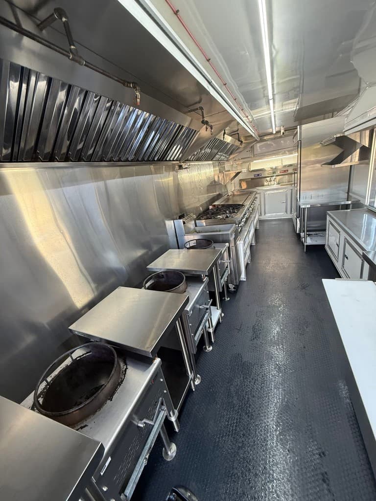 Spotless commercial food truck kitchen with gleaming stainless steel surfaces